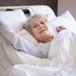 an eldering woman lying on the bed