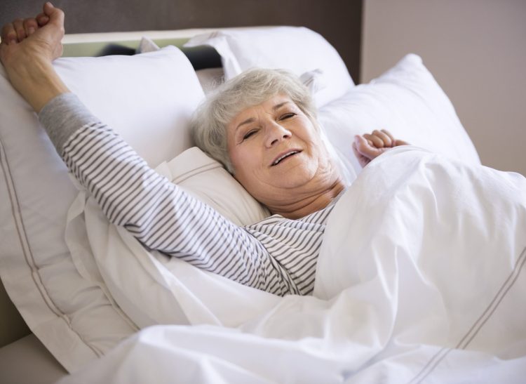 an eldering woman lying on the bed